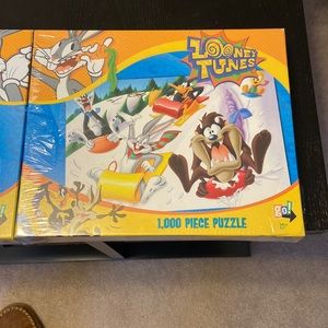 2 puzzles.  Looney Toons.  1000 pieces each.   One new and one built once